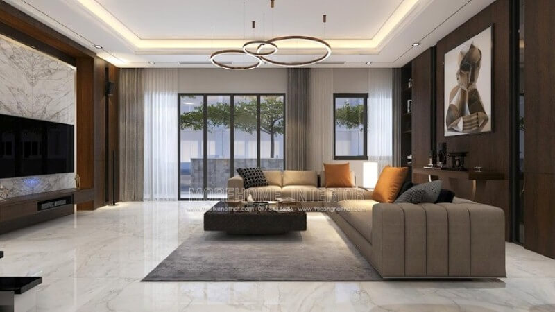 Bố trí nội thất phòng khách thể hiện vẻ đẹp nổi bật với mọi ánh nhìn. Ngồi trên chiếc sofa êm ái chiêm ngưỡng bức tranh trừu tượng như một ẩn số khiến ta tò mò những giây phút tĩnh lặng hay thay đổi sự quan tâm sang chiếc tivi giúp tầm mắt được nhìn một cách tập trung với cách trang trí khối đá đối vân trắng. Mẫu nội thất biệt thự đẹp